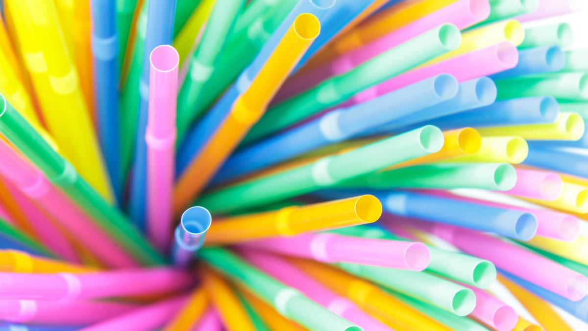 Making a sip. Female lips while drinking with straw. Drinking straw.  Drinking tube is a small