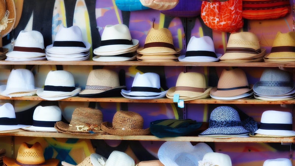 Different Style Men Hats on a Shelf of a Street Market. on
